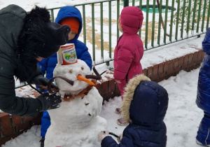 Dzieci lepią bałwana.