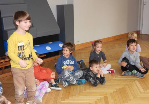 Ratownik medyczny opowiada dzieciom o udzielaniu pierwszej pomocy.