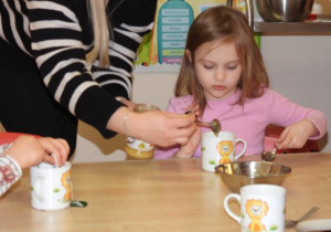 Dzieci przygotowują i piją zimową herbatkę.